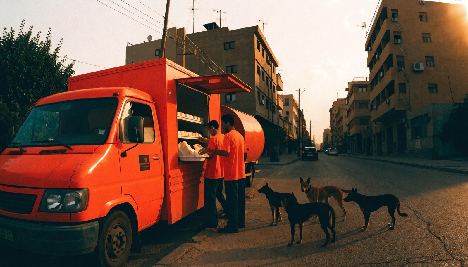 The food truck at sunrise with volunteers serving